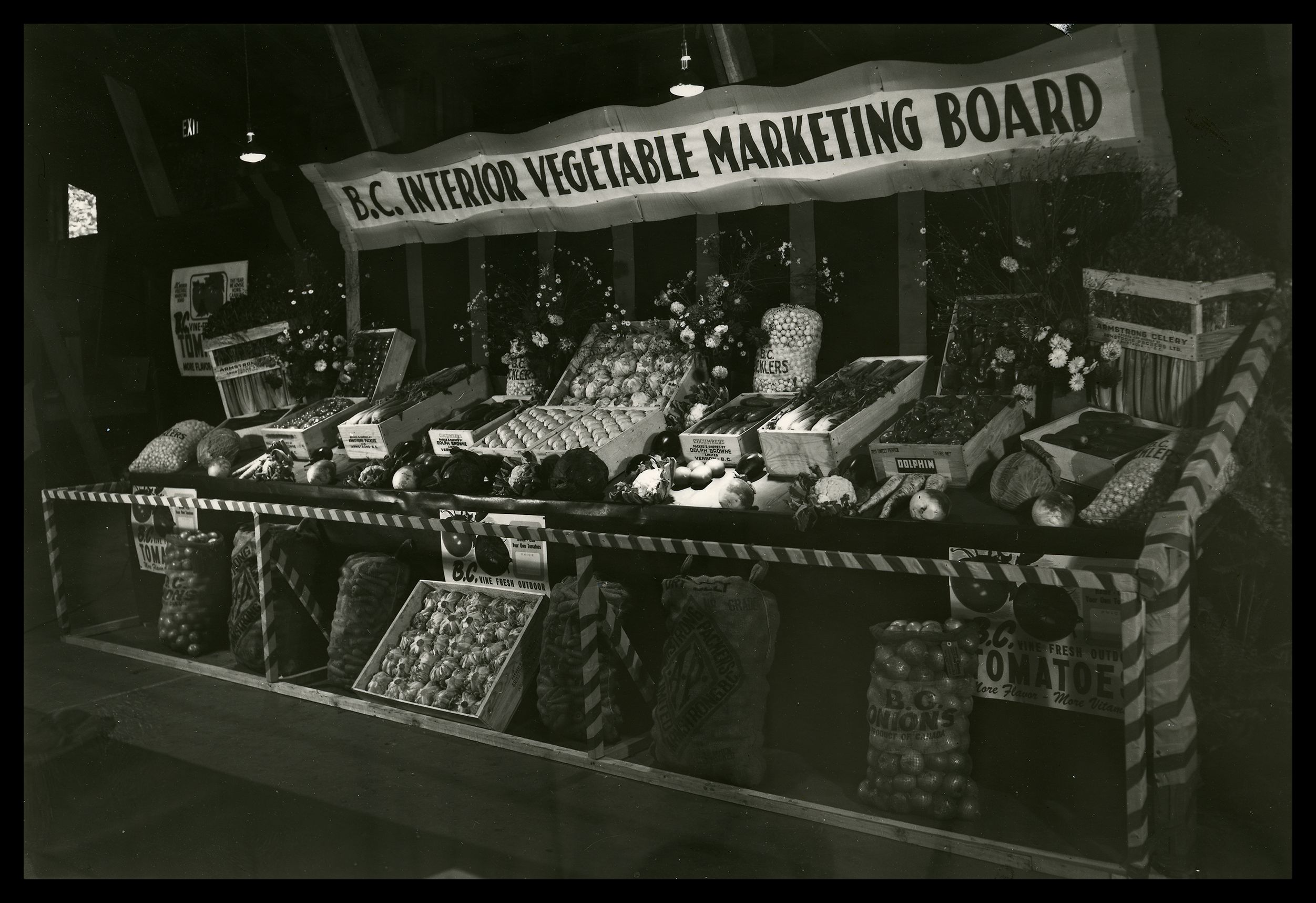  Vegetable Marketing Board display. Bins of Okanagan fruit.